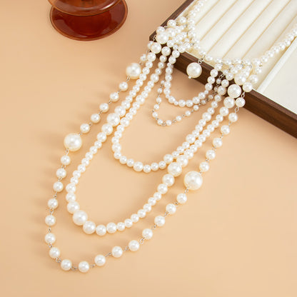Pearl and Silvertone ‌Graduated Bead Tassel Statement Necklace, dainty minimalist design, side view