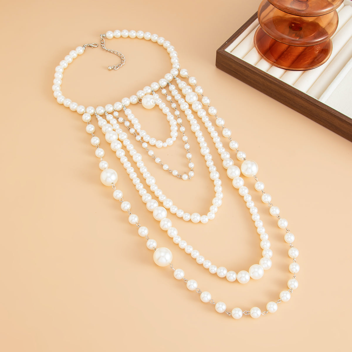 Pearl and Silvertone ‌Graduated Bead Tassel Statement Necklace, dainty minimalist design, detail close-up