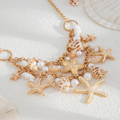 Pearl and Goldtone Starfish Conch Cluster Statement Necklace, dainty minimalist design, detail close-up