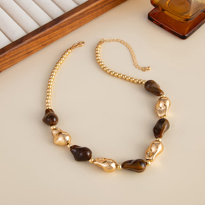 Brown Resin and Goldtone Irregular Drop Station Collar Necklace, botanical inspired, detail close-up