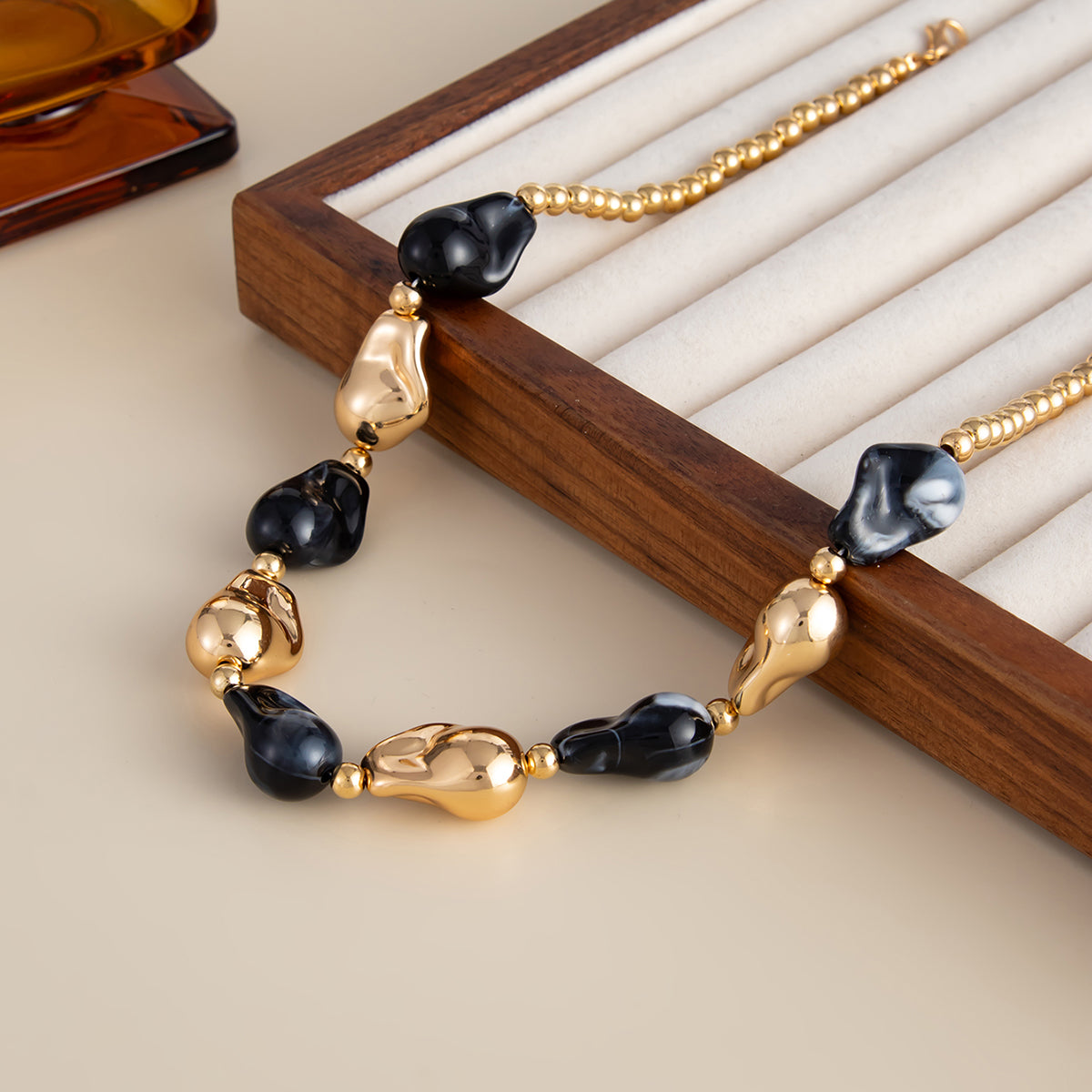 Black Resin and Goldtone Irregular Drop Station Collar Necklace, everyday style, detail close-up