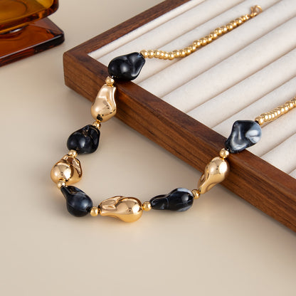 Black Resin and Goldtone Irregular Drop Station Collar Necklace, everyday style, detail close-up