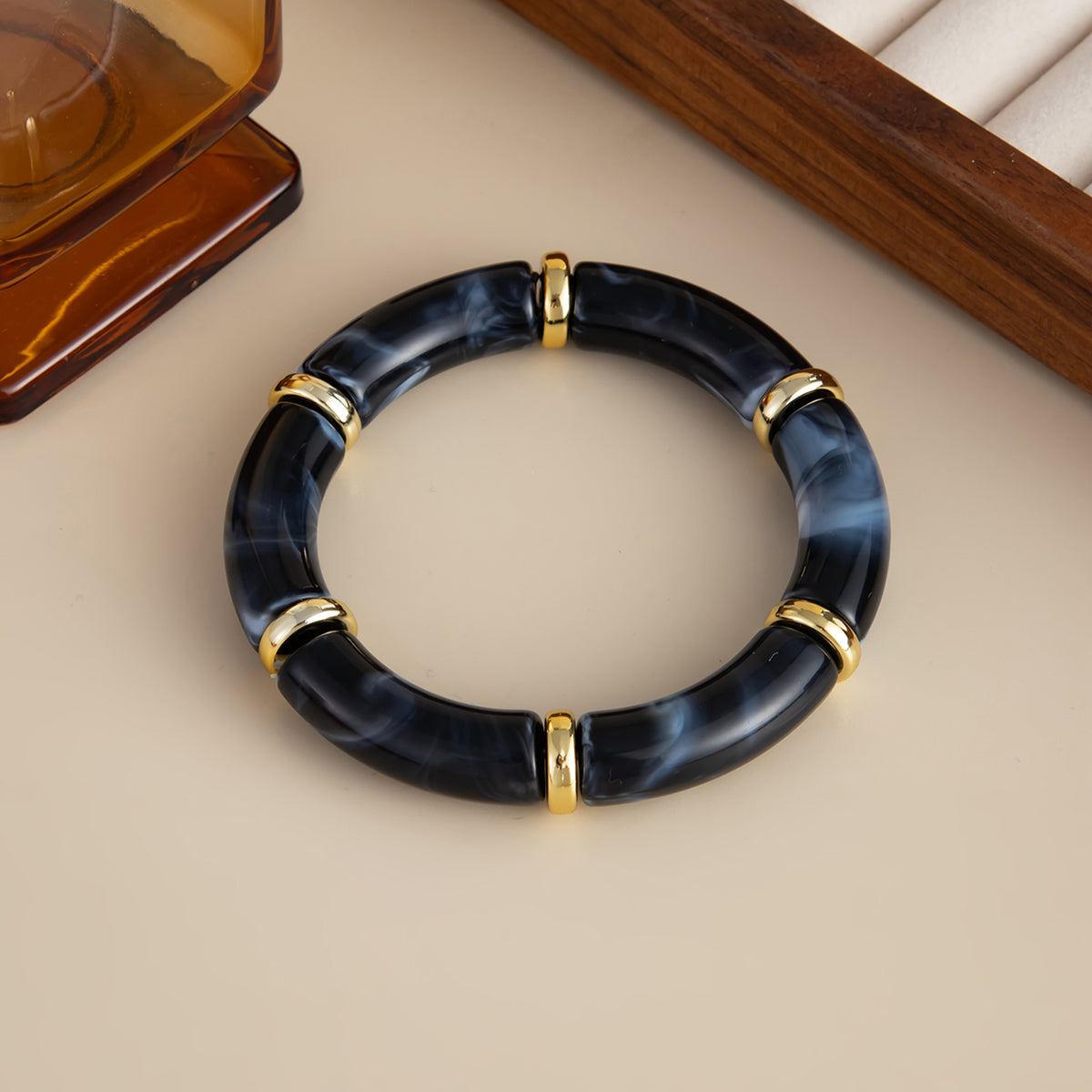 Black Resin and Goldtone Sequin Joint Stretch Bracelet, botanical inspired, detail close-up