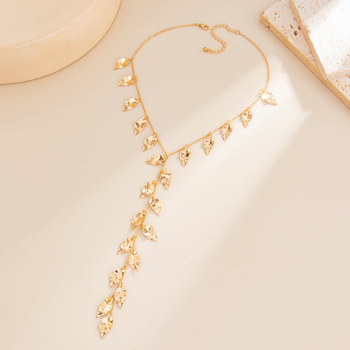 Goldtone Hammered Leaves Drop Necklace, botanical inspired, side view