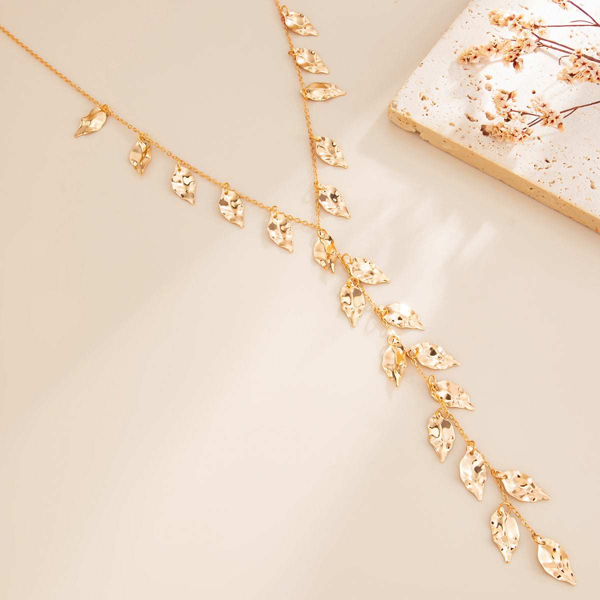 Goldtone Hammered Leaves Drop Necklace, botanical inspired, detail close-up