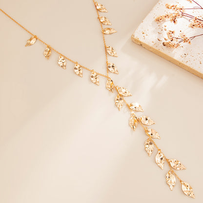 Goldtone Hammered Leaves Drop Necklace, botanical inspired, detail close-up