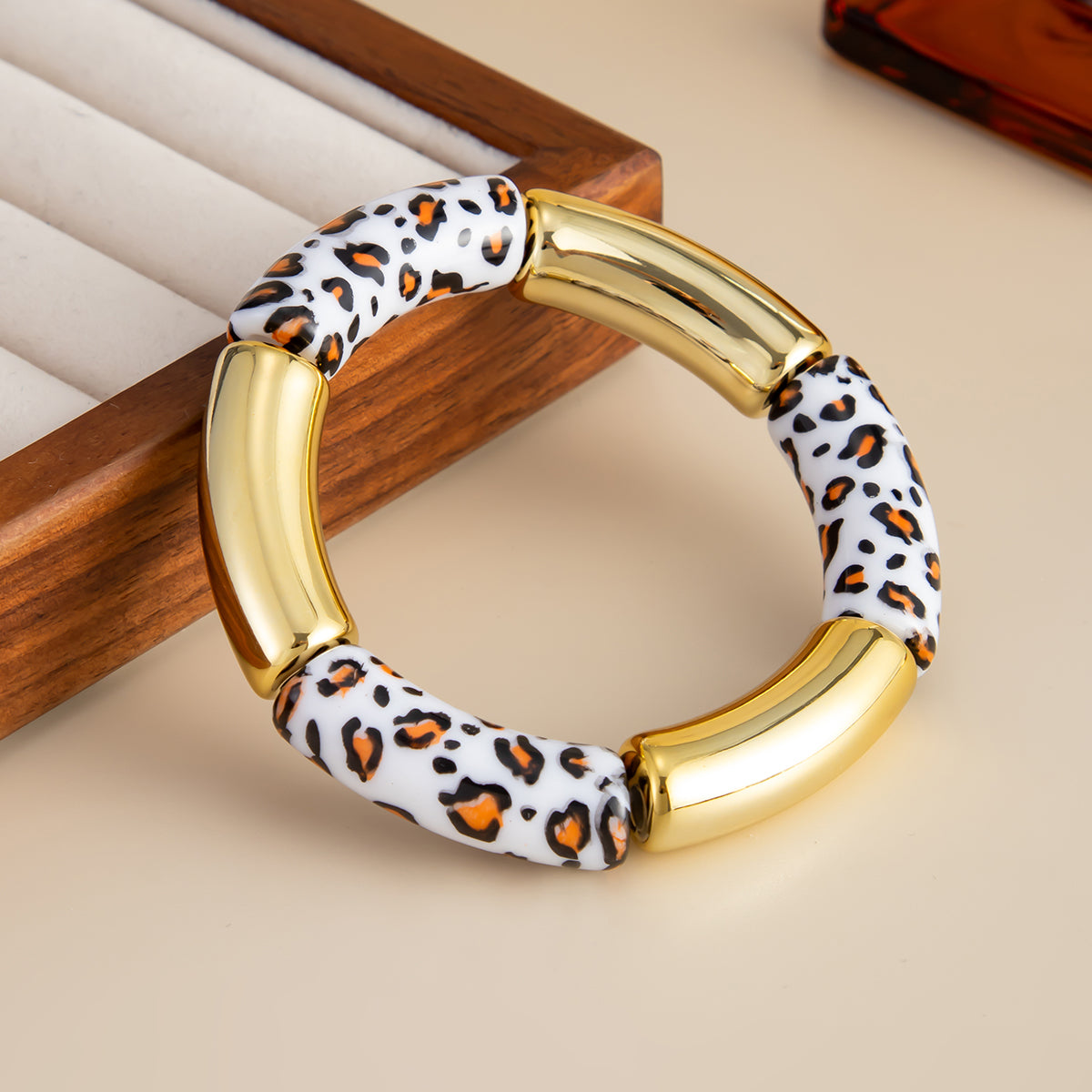 White Resin and Goldtone Cow Print Joint Stretch Bracelet, botanical inspired, side view