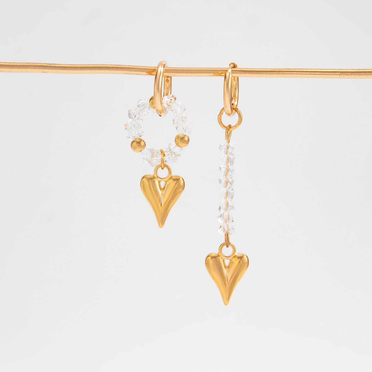 Clear Acrylic and Goldtone Mismatching Heart Dangle Earrings, dainty minimalist design, side view