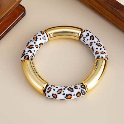 White Resin and Goldtone Cow Print Joint Stretch Bracelet, botanical inspired, detail close-up