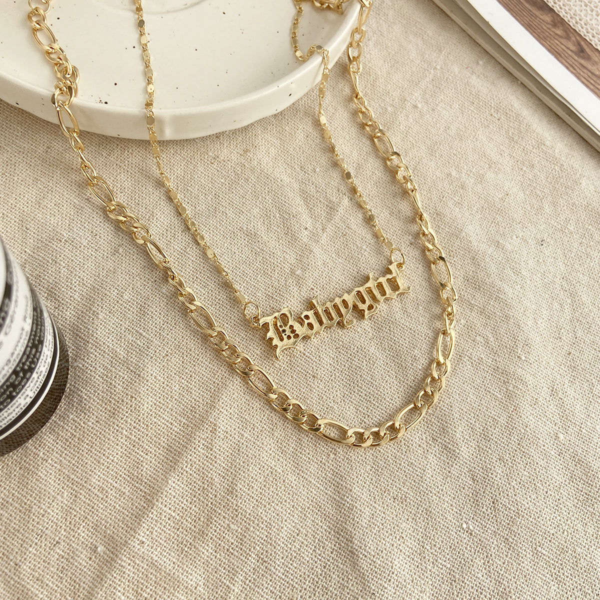 Dazzling 18K gold-plated layered bar necklace, personalized with the name 'Baby Girl' in exquisite gold finish.