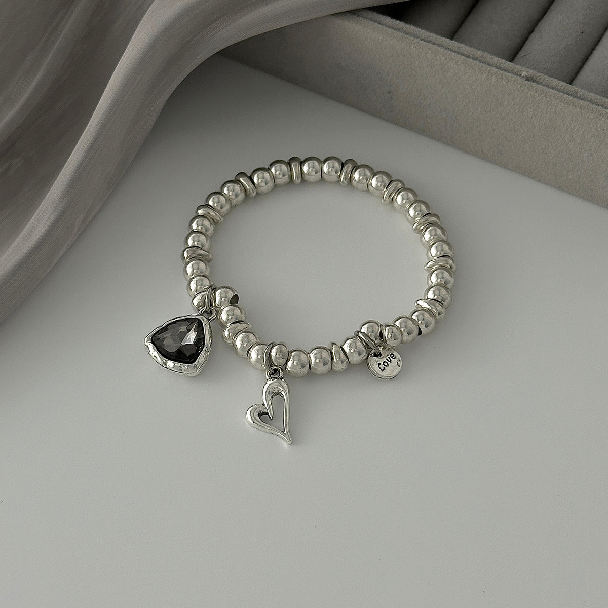 Crystal and Silvertone Open Heart Charm Stretch Bracelet, silver bracelet for women, vintage-inspired design, detail close-up