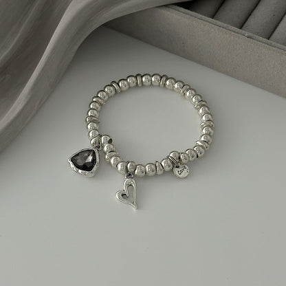 Crystal and Silvertone Open Heart Charm Stretch Bracelet, silver bracelet for women, vintage-inspired design, detail close-up