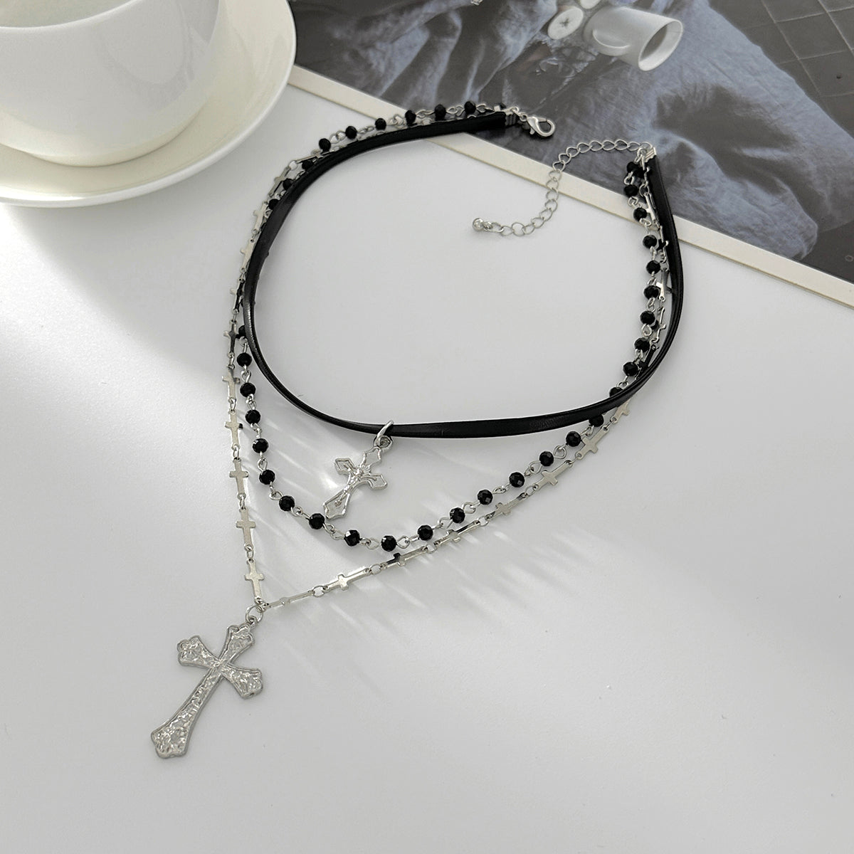 Black Polyurethane and Acrylic Silvertone Cross Pendant Layered Necklace, botanical inspired, side view