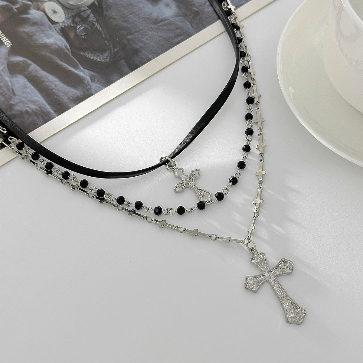 Black Polyurethane and Acrylic Silvertone Cross Pendant Layered Necklace, botanical inspired, detail close-up