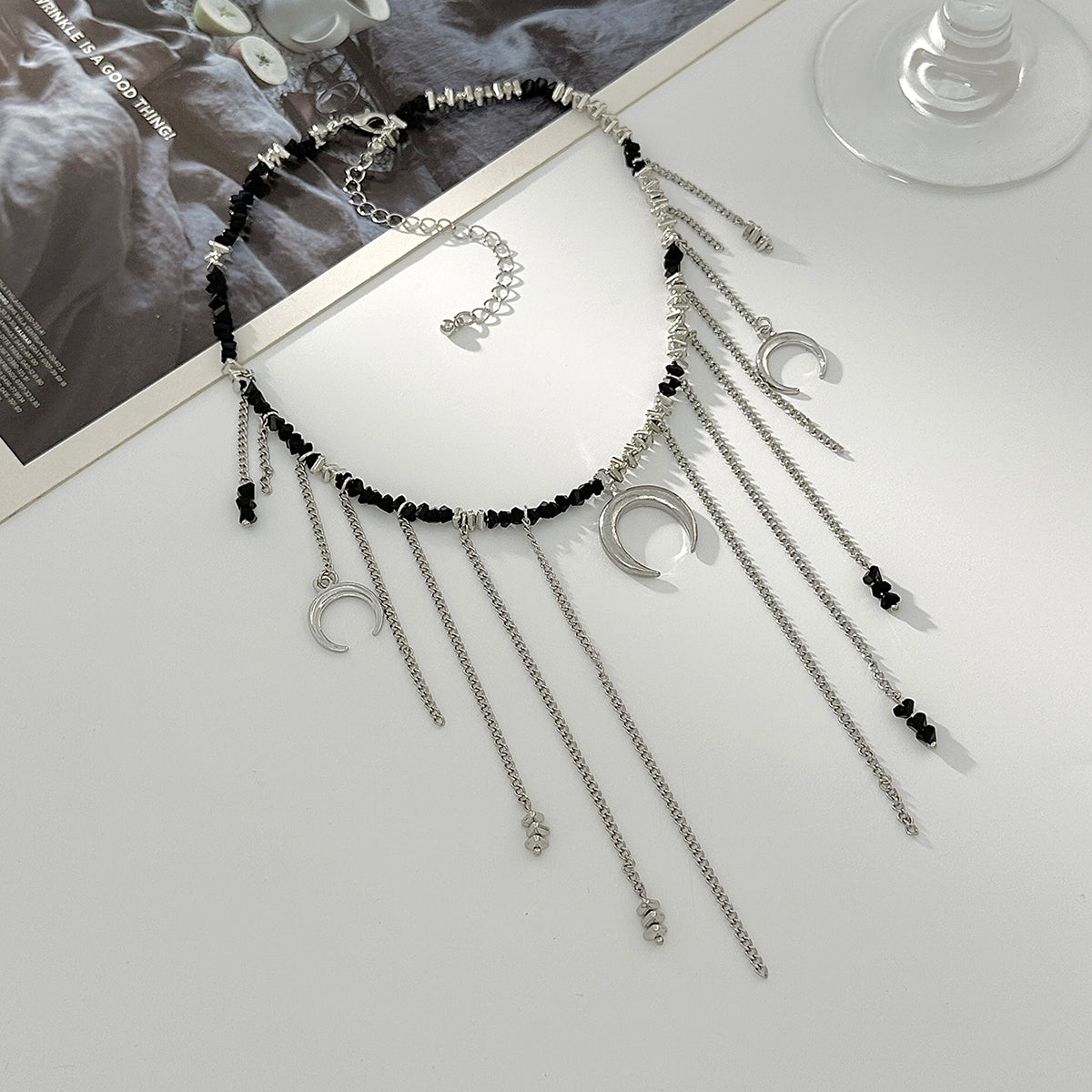 Black Acrylic and Silvertone Moon Pendant Tassel Necklace, vintage-inspired design, side view