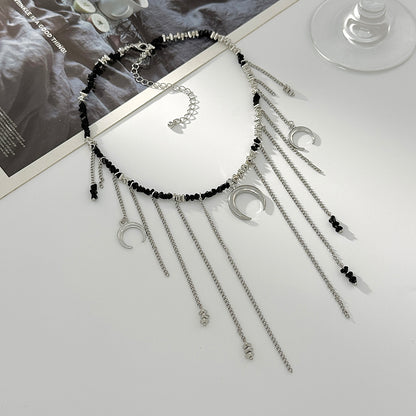 Black Acrylic and Silvertone Moon Pendant Tassel Necklace, vintage-inspired design, side view