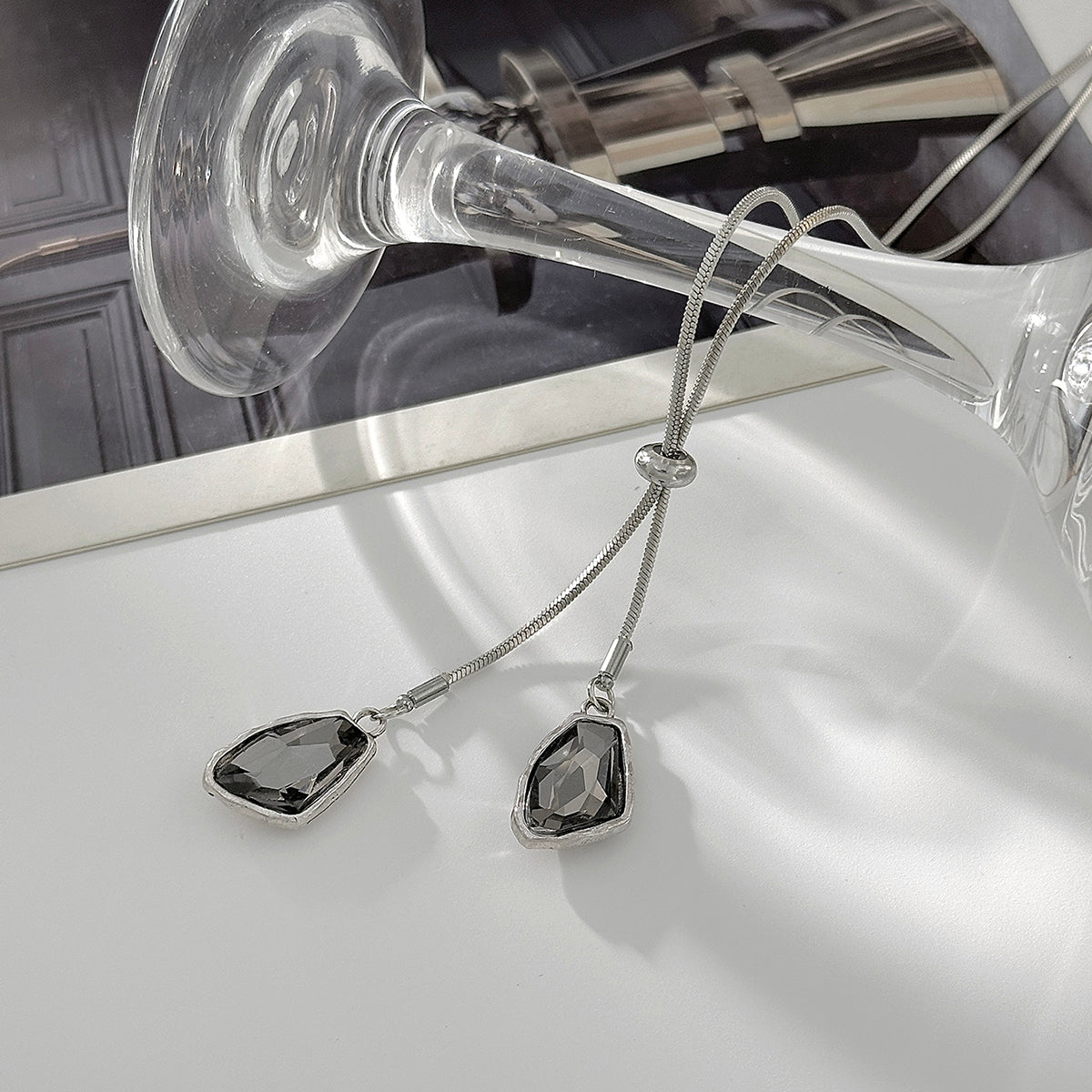 Crystal and Silvertone ‌Trapezium‌ Dual-Drop Long Necklace, botanical inspired, detail close-up