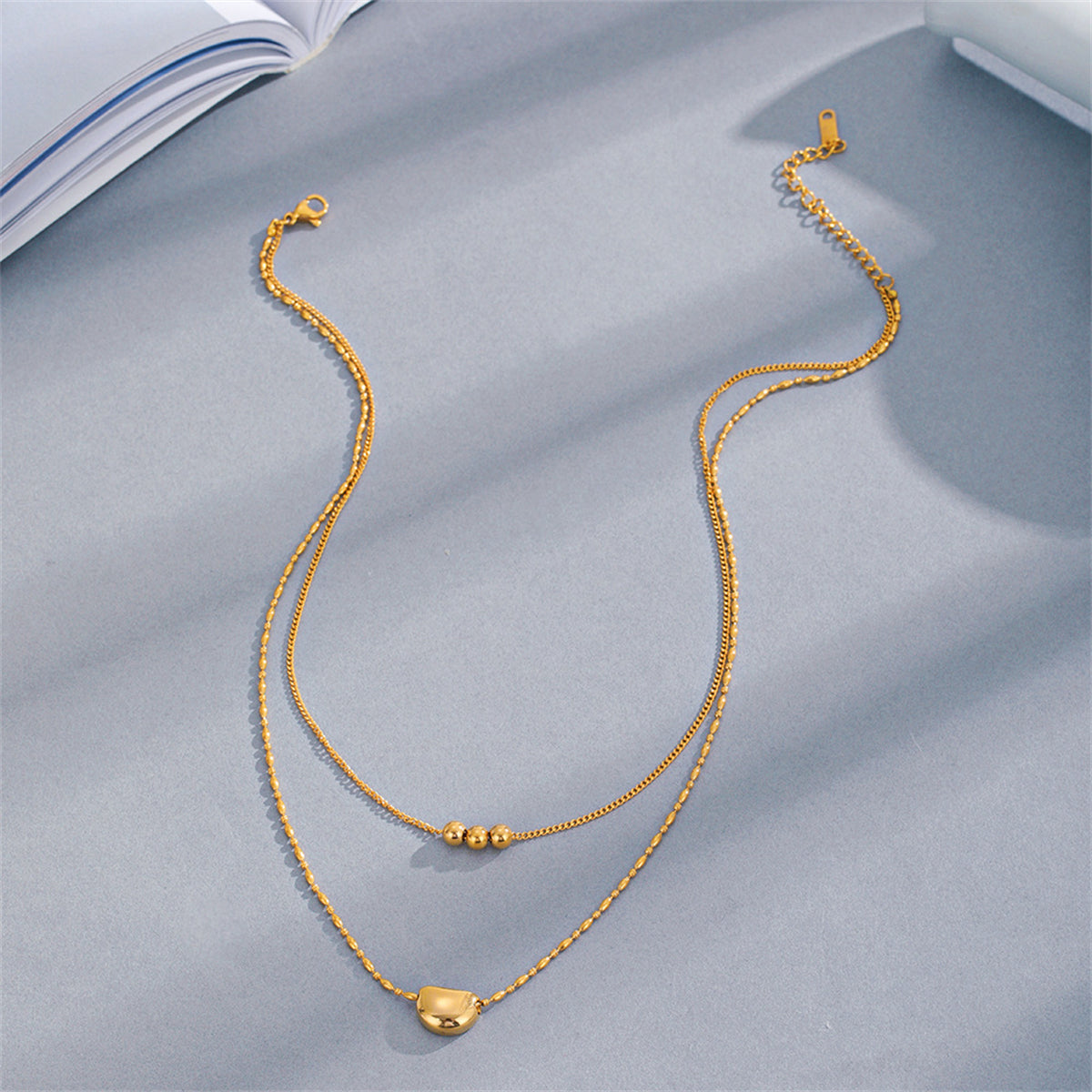 Beautifully crafted 18K gold-plated layered necklaces, each adorned with a delicate bead, ideal for elevating your style.
