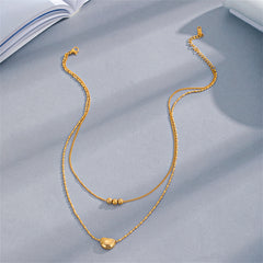 Beautifully crafted 18K gold-plated layered necklaces, each adorned with a delicate bead, ideal for elevating your style.