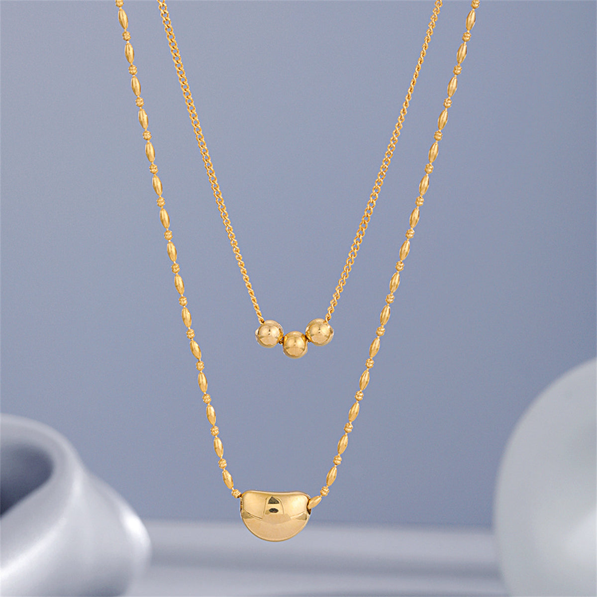 Stunning 18K gold-plated layered necklaces with chic beads on each chain, adding a touch of elegance to your outfit.