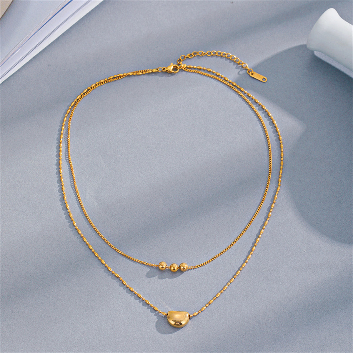 Elegant 18K gold-plated layered necklaces with beads on each chain, a must-have accessory for a fashionable wardrobe.