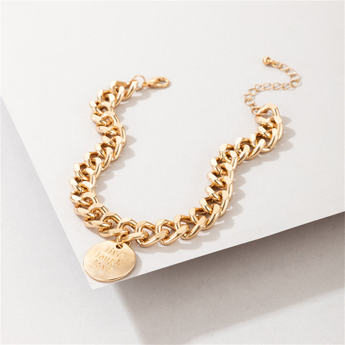 Trendy 18K gold-plated chunky curb chain anklet adorned with a coin charm, a stylish addition to any jewelry collection.
