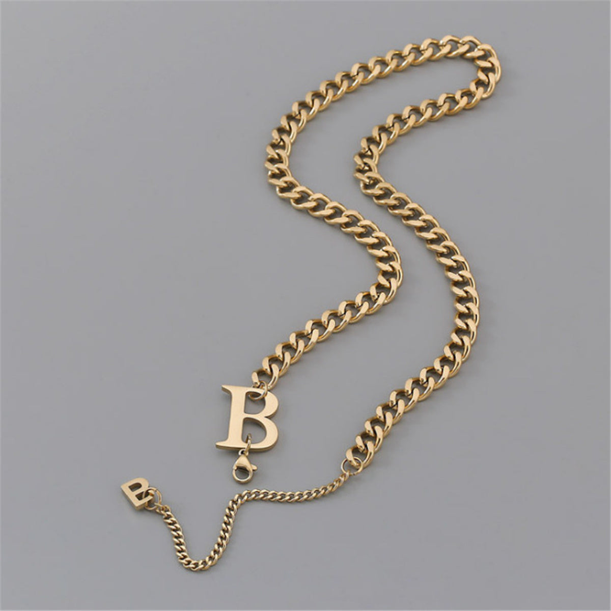Chic 18K gold-plated bracelet with a 'B' charm, showcasing a trendy Cuban chain design for a personalized accessory.