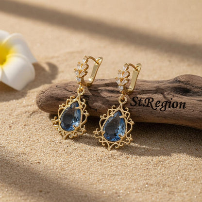 Blue Crystal and 18K Gold-Plated Scroll Drop Huggie Earrings, gold huggie earrings, botanical inspired, front view
