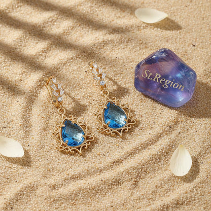 Blue Crystal and 18K Gold-Plated Scroll Drop Huggie Earrings, gold huggie earrings, botanical inspired, detail close-up