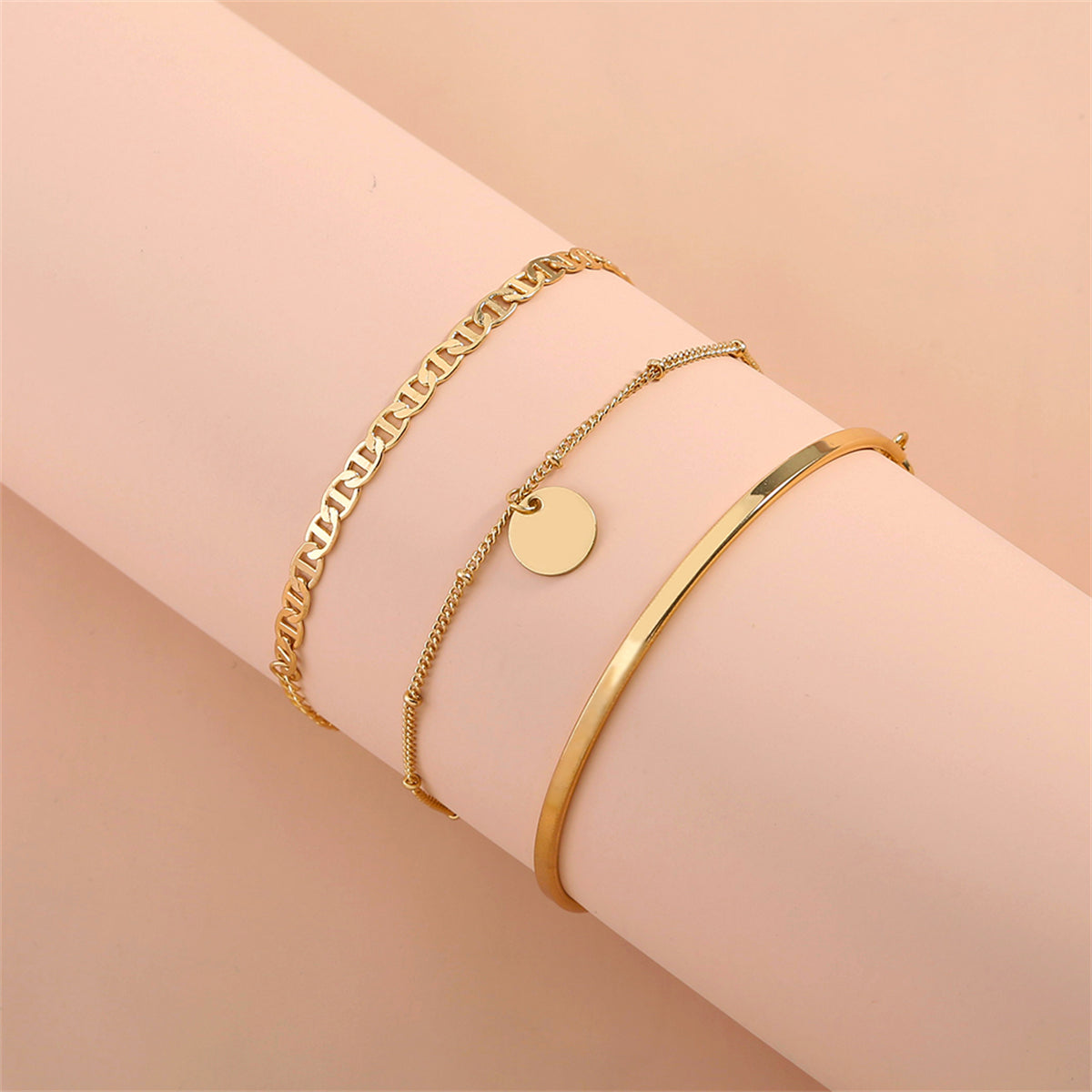 Three beautiful gold bracelets with a disc charm, showcasing 18K gold-plated elegance and sequin charm details.