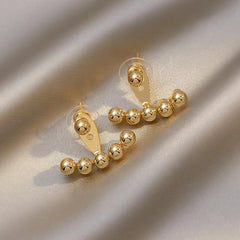 Chic pair of 18K gold-plated earrings with two gold ball studs and small beads, perfect for elevating your fashion game.