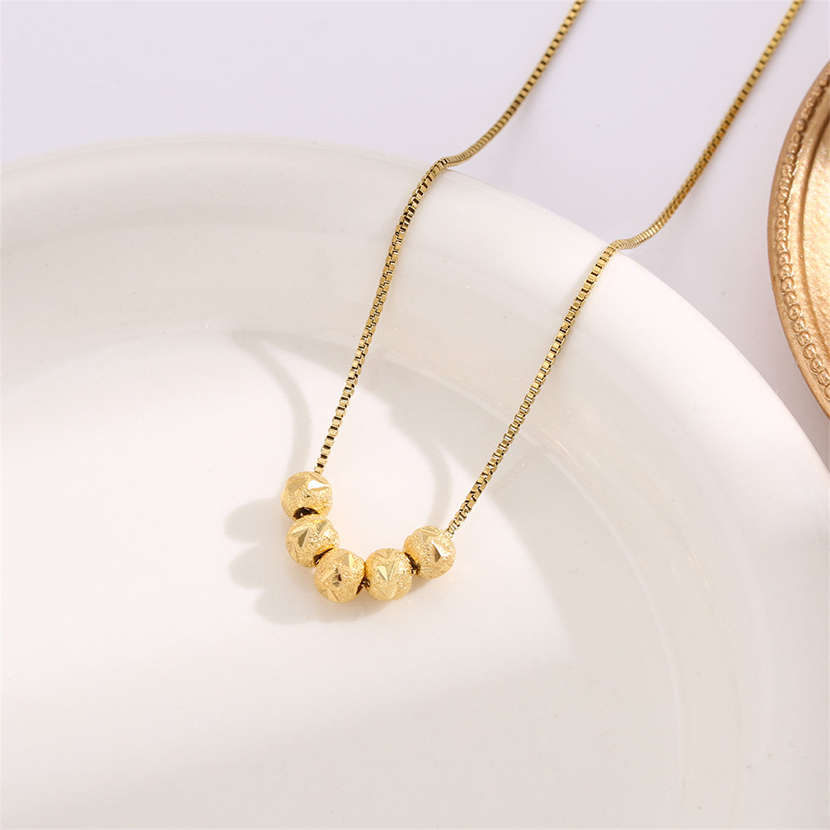 Fashionable 18K gold-plated bead necklace with four eye-catching balls, perfect for enhancing your everyday style.