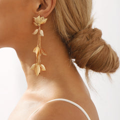 Elegant 18K gold plated drop earrings featuring intricate lotus and leaf designs, perfect for any occasion.