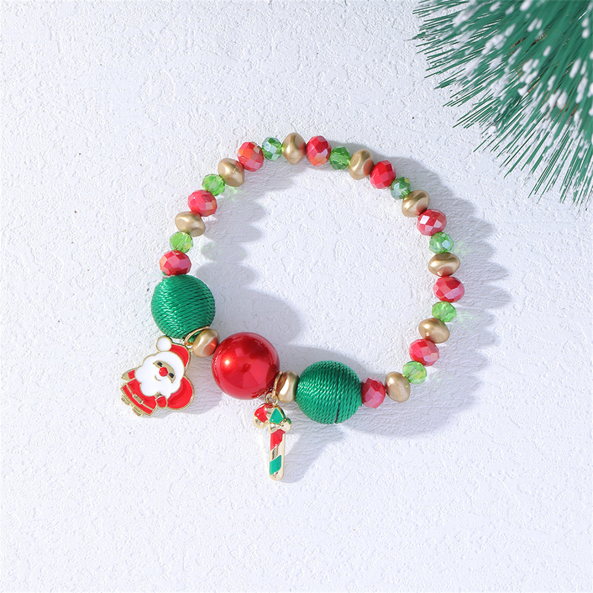 Beautifully crafted 18K gold-plated bracelet with Santa and Christmas tree charms, a stylish accessory for the holiday season.