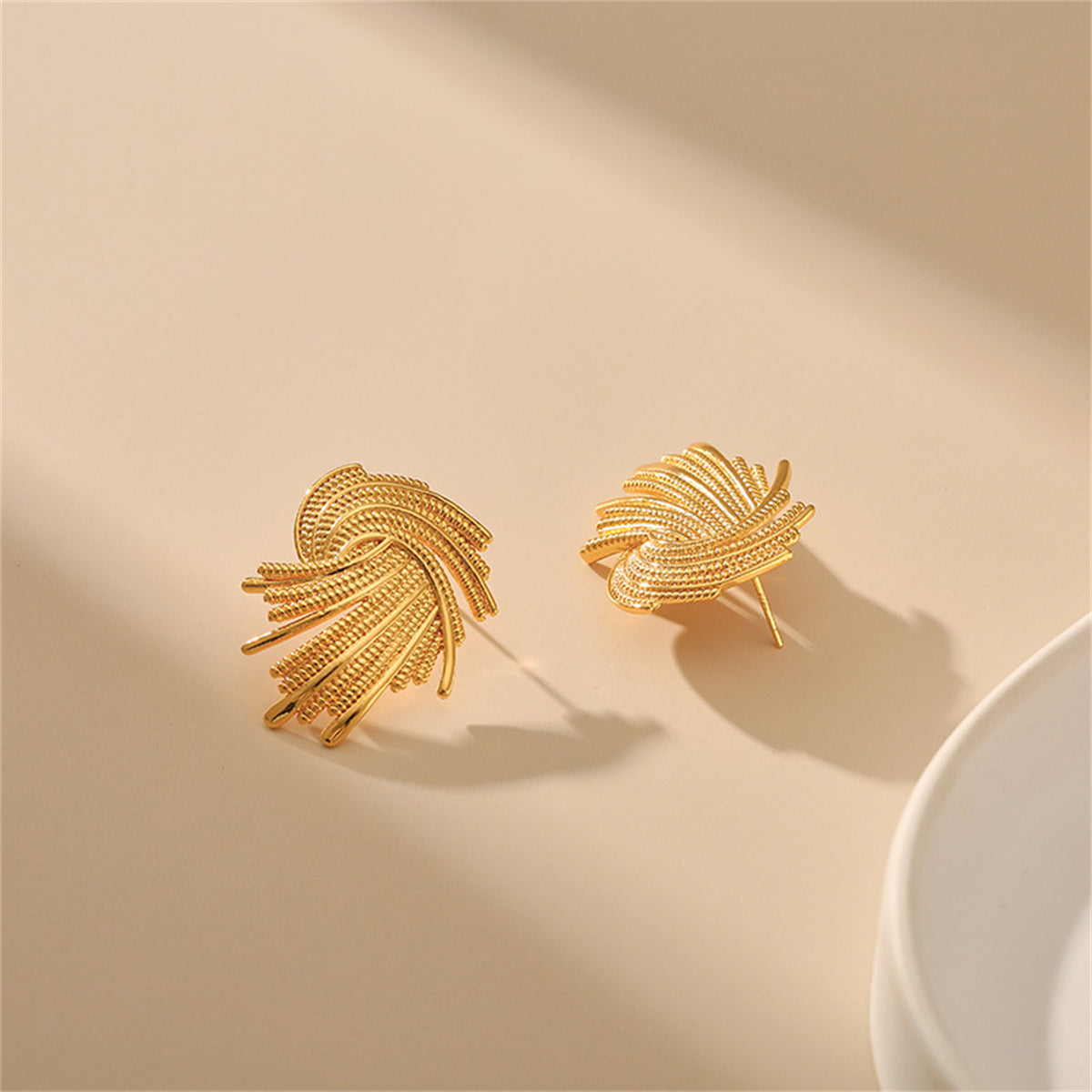 Chic 18K gold-plated earrings with an abstract spiral design, perfect for making a stylish statement on any occasion.