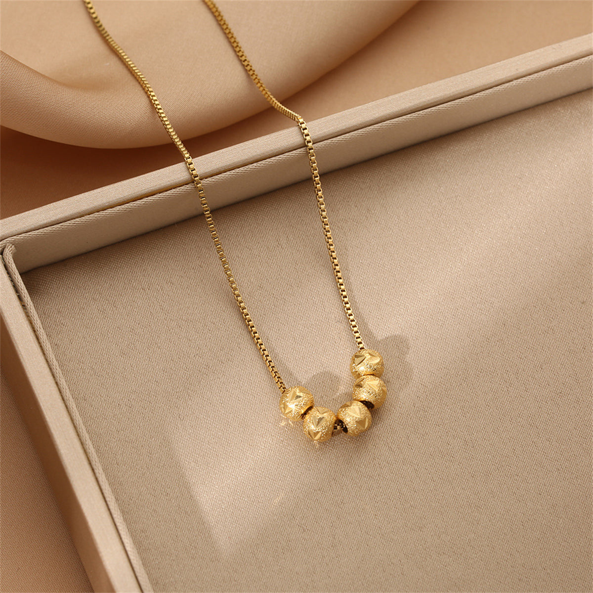Beautiful 18K gold-plated necklace showcasing four decorative balls, ideal for elevating your jewelry collection.