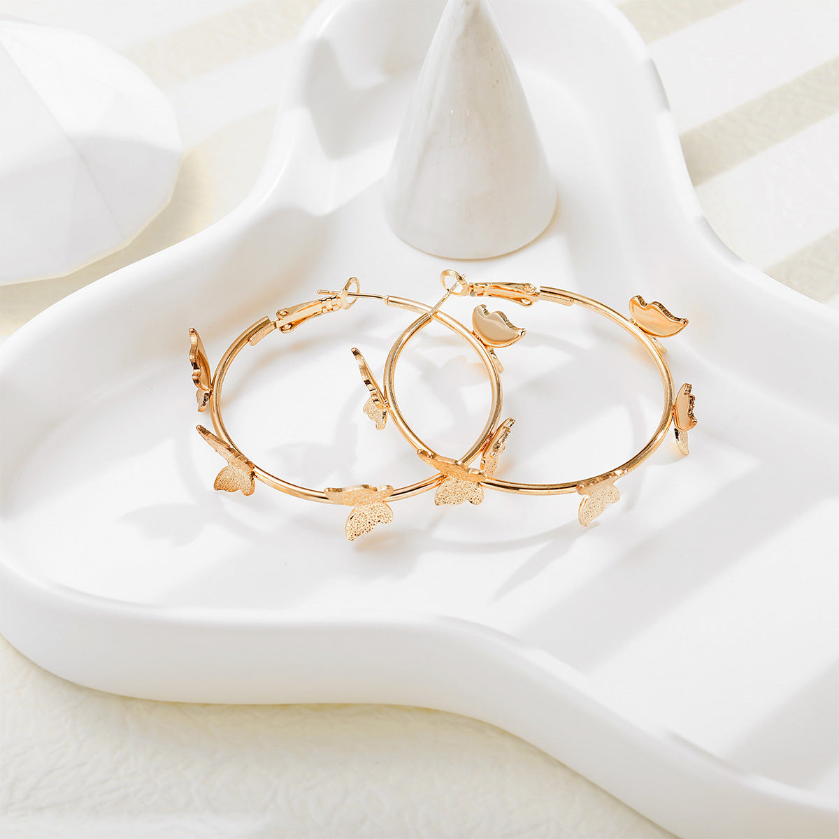 Chic 18K gold-plated butterfly hoop earrings, a must-have accessory that brings a whimsical touch to your look.