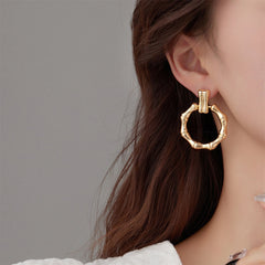 Trendy gold-plated bamboo earrings, elegantly designed as circle drops, perfect for enhancing your jewelry collection.