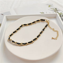 Sophisticated black and gold chain choker, designed with 18K gold-plated elements and a minimalist polystyrene cable chain.