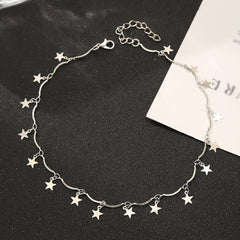 A silver-plated star choker necklace with small stars linked together, adding a whimsical touch to any outfit.