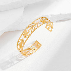 Stunning 18K gold-plated cuff bracelet with detailed botanical patterns, ideal for elevating your jewelry collection.