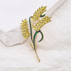 Stunning floral brooch in yellow and green, adorned with leaves, made from 18K gold-plated crystal and green enamel.