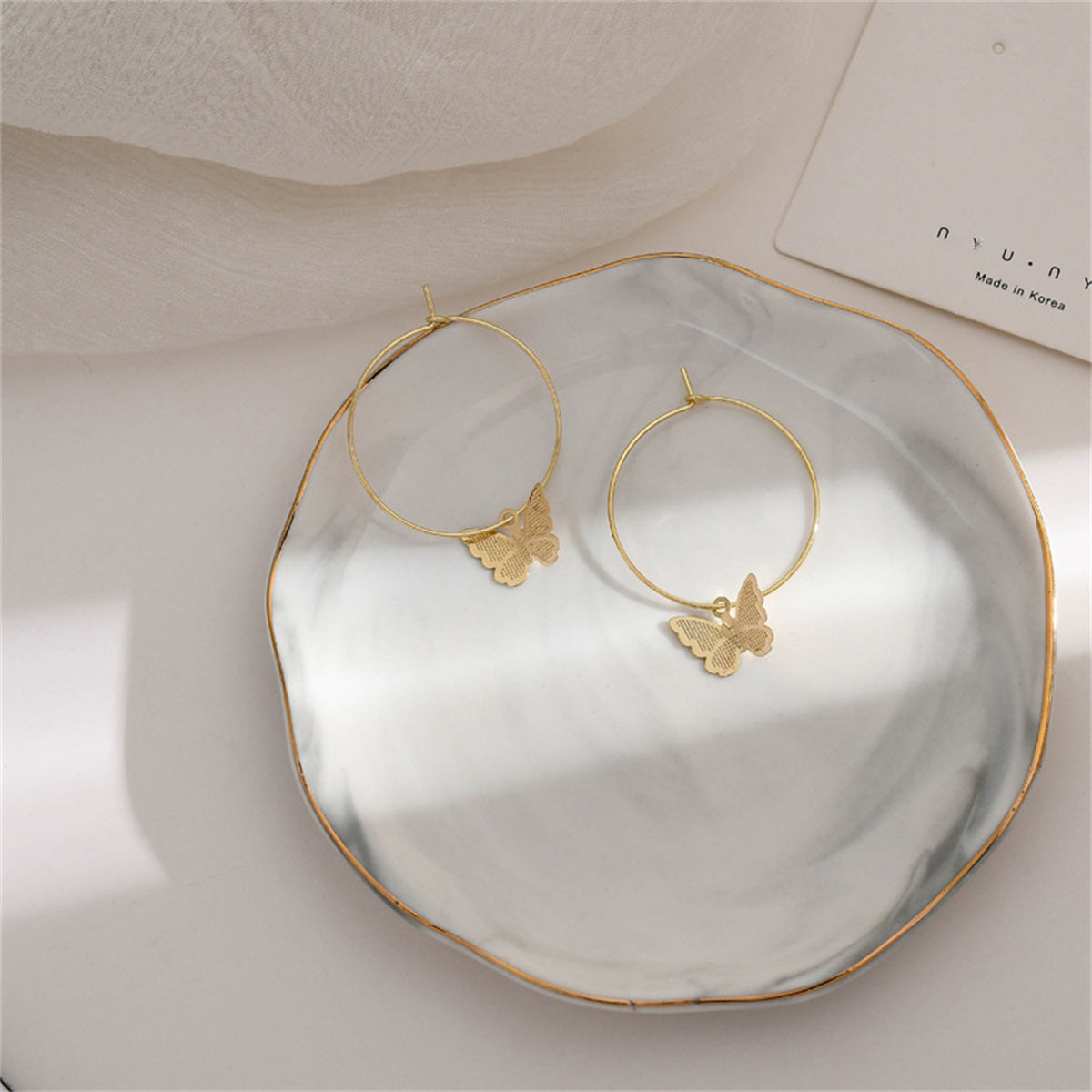 Charming 18K gold-plated butterfly huggie earrings, ideal for expressing your unique style with a touch of sophistication.