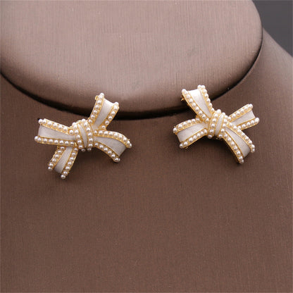 White Enamel and Pearl Bow Stud Earrings, stud earrings for women, everyday style, detail close-up