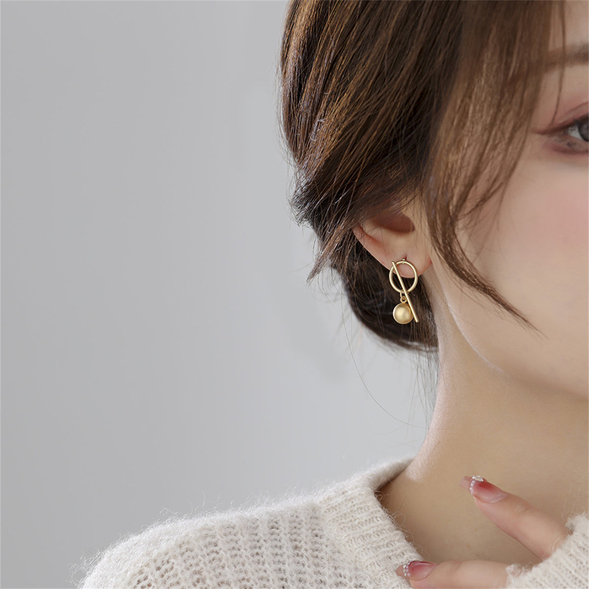 Chic 18K gold-plated earrings featuring a circle and cross design, a must-have accessory for any jewelry collection.