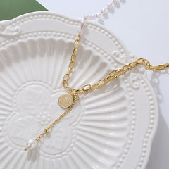 Beautiful gold chain necklace showcasing a pearl and a gold coin charm, ideal for elevating any outfit with elegance.