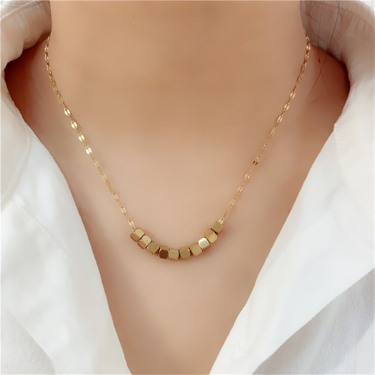 Eye-catching 18K gold-plated necklace featuring four sleek cubes, a must-have accessory for a contemporary look.