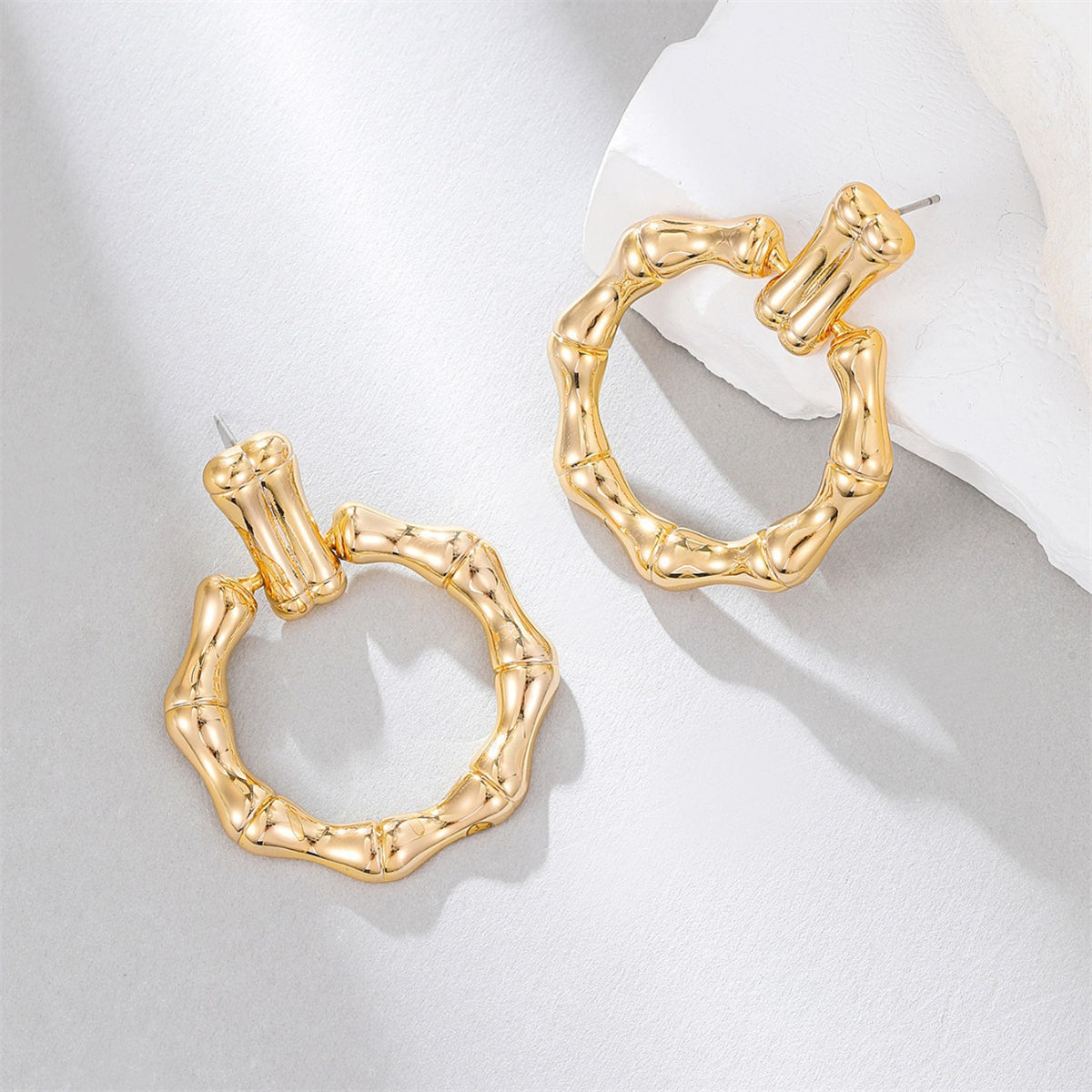 Stunning gold-plated bamboo earrings, featuring a stylish circle drop design that adds a touch of elegance to your outfit.