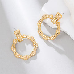 Stunning gold-plated bamboo earrings, featuring a stylish circle drop design that adds a touch of elegance to your outfit.