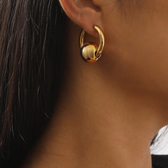 Dazzling 18K gold-plated ball huggie earrings, offering a timeless gold tone that complements any fashion-forward ensemble.